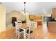 Open concept dining area connected to the kitchen and living room with ample natural light at 4572 Mulberry Fields Ln, Auburn, GA 30011