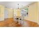 Sunny dining area with hardwood floors, a pendant light, and access to the backyard at 4572 Mulberry Fields Ln, Auburn, GA 30011