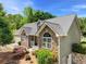 Charming home featuring a stone facade, landscaped yard, and a well-maintained lawn at 4572 Mulberry Fields Ln, Auburn, GA 30011