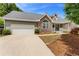 Beautiful home with stone accents, attached garage, and a driveway at 4572 Mulberry Fields Ln, Auburn, GA 30011