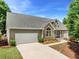 Side view of a well-maintained house with an attached garage and landscaped yard at 4572 Mulberry Fields Ln, Auburn, GA 30011