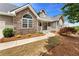 Charming home with stone accents, manicured landscaping and covered front porch entry at 4572 Mulberry Fields Ln, Auburn, GA 30011