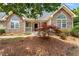 Front of the house with stone detail, front porch, and landscaping at 4572 Mulberry Fields Ln, Auburn, GA 30011
