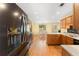 Updated kitchen offering stainless steel refrigerator and dishwasher, stained cabinets, and hardwood floors at 4572 Mulberry Fields Ln, Auburn, GA 30011