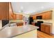 Traditional kitchen with oak cabinets, stainless steel sink, and modern black appliances at 4572 Mulberry Fields Ln, Auburn, GA 30011