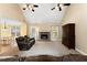 Bright living room featuring a stone fireplace, plush seating, and a ceiling fan at 4572 Mulberry Fields Ln, Auburn, GA 30011