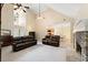 Spacious living room featuring high ceilings, a stone fireplace, and access to other areas at 4572 Mulberry Fields Ln, Auburn, GA 30011