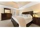 A primary bedroom featuring neutral carpet, furniture, and trey ceilings providing a relaxing atmosphere at 4572 Mulberry Fields Ln, Auburn, GA 30011