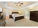 Spacious main bedroom featuring a tray ceiling, neutral carpet, and a walk-in closet at 4572 Mulberry Fields Ln, Auburn, GA 30011