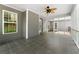 Spacious screened porch with tiled floors and a ceiling fan, perfect for outdoor entertaining at 4572 Mulberry Fields Ln, Auburn, GA 30011
