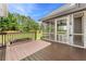 Exterior view of the screened porch accessible from the wooden deck and overlooking the backyard at 4572 Mulberry Fields Ln, Auburn, GA 30011