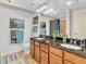 Neutral bathroom features double sink vanity with granite counters and shower/tub combination at 200 River Vista Dr # 436, Atlanta, GA 30339