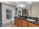 Bathroom with double sinks, granite counters, and a separate tub at 200 River Vista Dr # 436, Atlanta, GA 30339