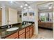 Bathroom boasts a double sink vanity with granite countertops and a view into the main bedroom at 200 River Vista Dr # 436, Atlanta, GA 30339