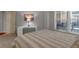 Bedroom showcasing a striped comforter and natural light at 200 River Vista Dr # 436, Atlanta, GA 30339