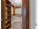Spacious walk-in closet with custom shelving and a chandelier at 200 River Vista Dr # 436, Atlanta, GA 30339
