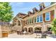 Community clubhouse with an outdoor kitchen, BBQ area, stone accents, and plenty of seating for entertaining at 200 River Vista Dr # 436, Atlanta, GA 30339