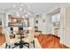 Dining area with modern light fixture and hardwood floors, adjacent to open kitchen at 200 River Vista Dr # 436, Atlanta, GA 30339