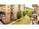 Multi-story apartment building boasts lush landscaping, multiple balconies, and park-like green space for relaxing at 200 River Vista Dr # 436, Atlanta, GA 30339