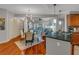 Open-concept living and dining area with hardwood floors and stylish lighting, creating a warm, inviting space at 200 River Vista Dr # 436, Atlanta, GA 30339