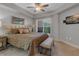 Comfortable main bedroom featuring tray ceiling, ceiling fan, and soft natural light at 200 River Vista Dr # 436, Atlanta, GA 30339