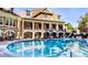 Resort-style pool area with comfortable lounge chairs, a clubhouse, and manicured landscaping for a relaxing experience at 200 River Vista Dr # 436, Atlanta, GA 30339