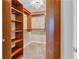 Spacious walk-in closet with custom wood shelving and elegant chandelier lighting at 200 River Vista Dr # 436, Atlanta, GA 30339