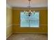 A dining area featuring neutral walls, natural light, and a chandelier at 3218 Watson Woods Way, Loganville, GA 30052