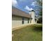 Exterior view of home highlighting neutral siding, chimney, and well-maintained lawn at 3218 Watson Woods Way, Loganville, GA 30052