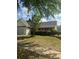 Traditional home featuring a well-maintained front yard with mature trees and lawn at 3218 Watson Woods Way, Loganville, GA 30052
