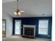 Living room with fan, stone fireplace, and natural light from the back door at 3218 Watson Woods Way, Loganville, GA 30052