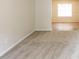 Open living area with neutral carpet flooring flowing into the dining area at 3652 Arrowhead Pl, Douglasville, GA 30135