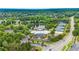 Aerial shot of a neighborhood pool, tennis courts, and a pond surrounded by lush trees at 4325 Acanthite Ct, Cumming, GA 30040
