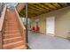The back porch has a door, two windows, red chairs, and stairs leading to the upper deck at 4325 Acanthite Ct, Cumming, GA 30040