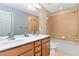 Bathroom features a double vanity and a shower with tile walls at 4325 Acanthite Ct, Cumming, GA 30040