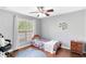 Cozy bedroom featuring a ceiling fan, wood floors, and bright natural light at 4325 Acanthite Ct, Cumming, GA 30040