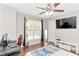 Bright bedroom with a ceiling fan, hardwood floors, and a large window at 4325 Acanthite Ct, Cumming, GA 30040