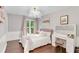 Well-lit bedroom with hardwood floors, neutral gray paint, a vanity area and decor accents at 4325 Acanthite Ct, Cumming, GA 30040