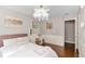 Bright bedroom with hardwood floors, neutral gray paint, a vanity area and statement chandelier at 4325 Acanthite Ct, Cumming, GA 30040