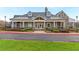 Exterior view of a clubhouse with stone and siding facade, porch with columns and landscaping at 4325 Acanthite Ct, Cumming, GA 30040