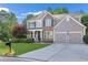 Charming two-story home with stone accents, a well-manicured lawn, and a two-car garage at 4325 Acanthite Ct, Cumming, GA 30040