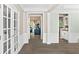 Bright hallway with neutral walls, hardwood flooring, and elegant white trim at 4325 Acanthite Ct, Cumming, GA 30040