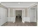 Inviting hallway with elegant trim, hardwood flooring, and entry to other rooms at 4325 Acanthite Ct, Cumming, GA 30040