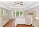 Sun-filled main bedroom with trey ceilings, wood floors, neutral decor and large windows at 4325 Acanthite Ct, Cumming, GA 30040