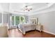 Sun-filled main bedroom with trey ceilings, wood floors, neutral decor and large windows at 4325 Acanthite Ct, Cumming, GA 30040