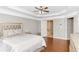 Spacious main bedroom with trey ceilings, wood floors and a peak into a connected bathroom at 4325 Acanthite Ct, Cumming, GA 30040