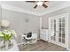 Bright home office with hardwood flooring, French doors, and a modern desk setup at 4325 Acanthite Ct, Cumming, GA 30040