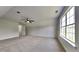 Expansive bedroom featuring carpet flooring, a ceiling fan, and views of the outside through a bright window at 64 Dogwood Rdg, Hampton, GA 30228