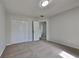 Light-filled bedroom with plush carpet and neutral paint; features built-in closet at 64 Dogwood Rdg, Hampton, GA 30228