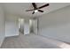 Spacious bedroom featuring neutral paint, plush carpeting, and a modern ceiling fan at 64 Dogwood Rdg, Hampton, GA 30228